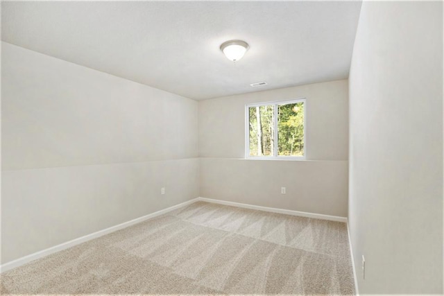 spare room with light carpet and vaulted ceiling