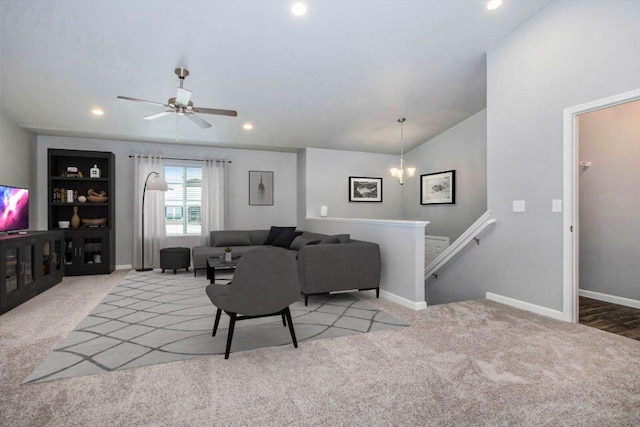 living room featuring ceiling fan, light colored carpet, and vaulted ceiling