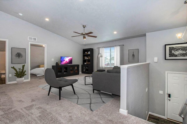 carpeted living room featuring ceiling fan and lofted ceiling