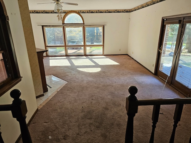 carpeted spare room featuring ceiling fan