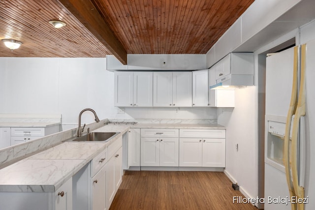 kitchen featuring white cabinets, sink, hardwood / wood-style flooring, light stone countertops, and white fridge with ice dispenser