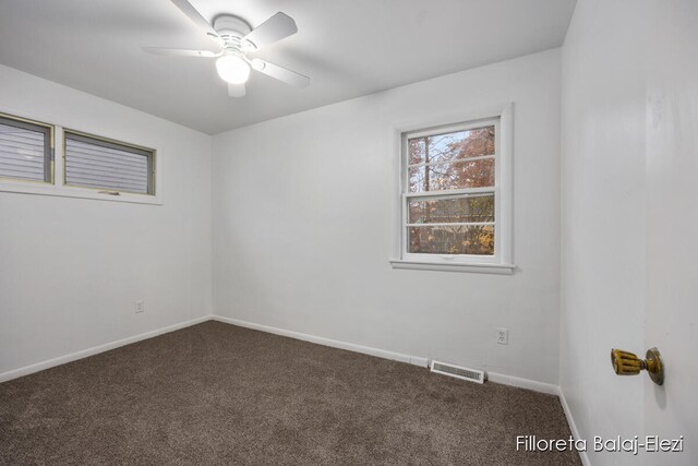 carpeted spare room featuring ceiling fan