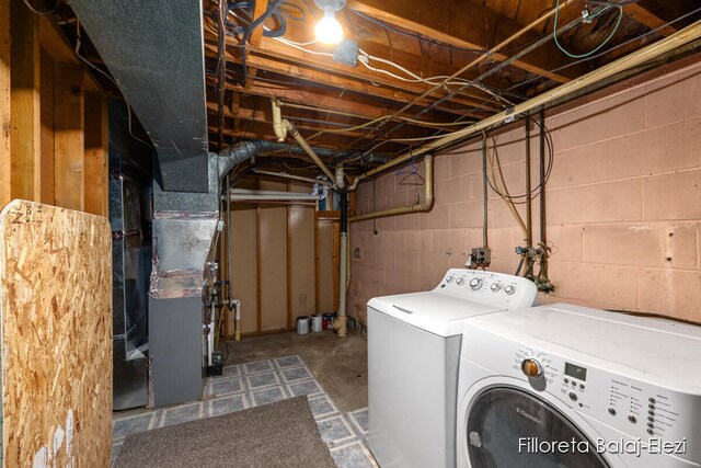 laundry area with washer and clothes dryer and heating unit