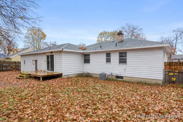 back of property with central AC unit and a deck