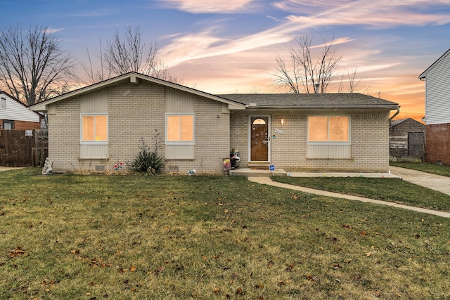 single story home with a lawn