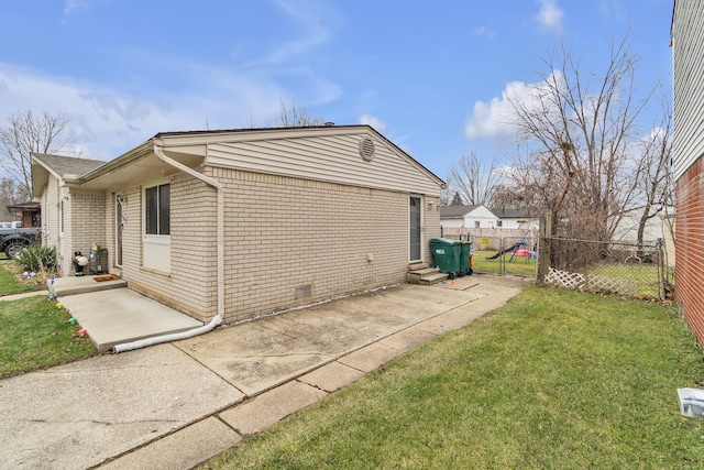 view of side of property with a lawn and a patio area