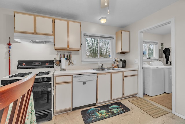 kitchen featuring white cabinets, white appliances, sink, and washing machine and clothes dryer