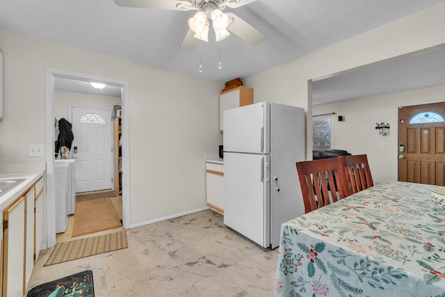 kitchen featuring ceiling fan and white fridge