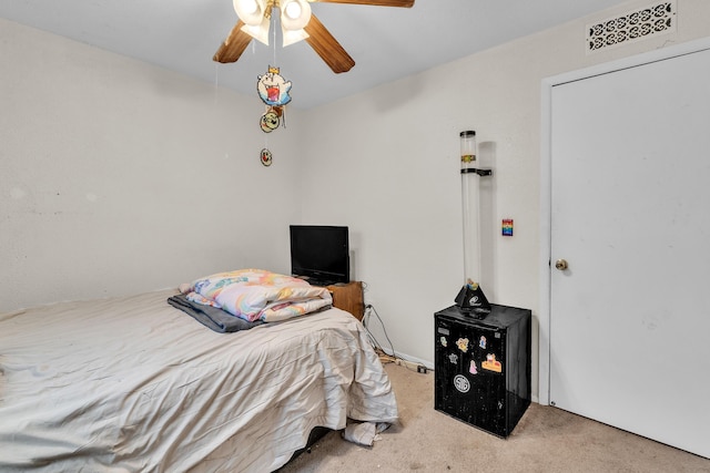 bedroom with ceiling fan and light carpet