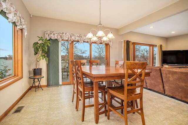 dining space featuring an inviting chandelier