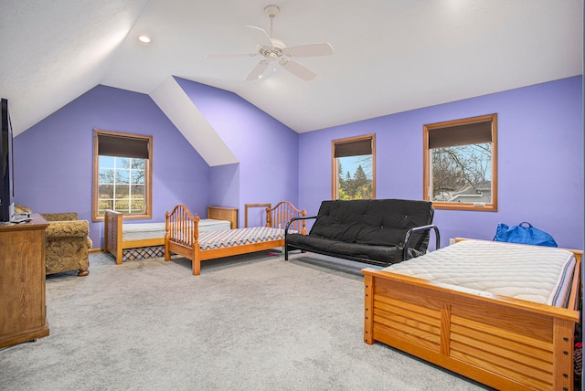 bedroom with ceiling fan, light carpet, and vaulted ceiling