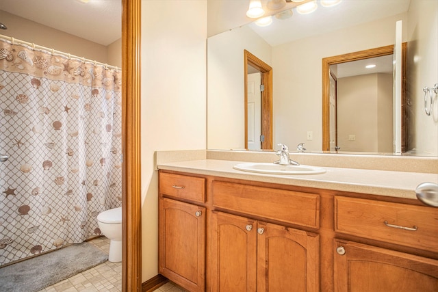 bathroom featuring tile patterned flooring, vanity, and toilet