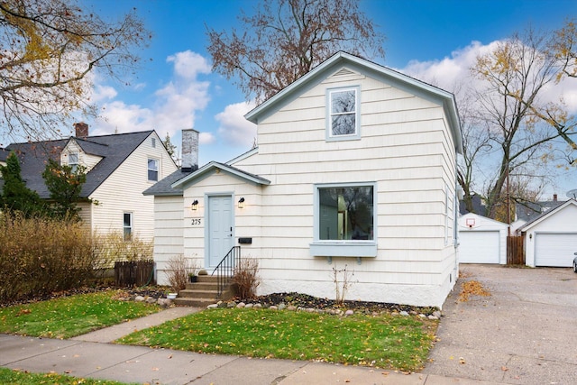 view of front facade with an outbuilding and a garage