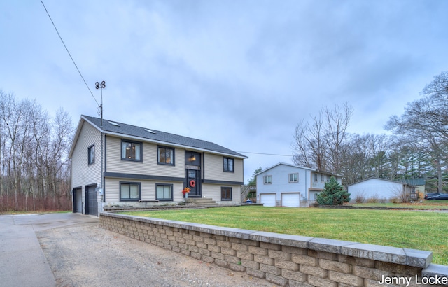 bi-level home featuring a front yard and a garage