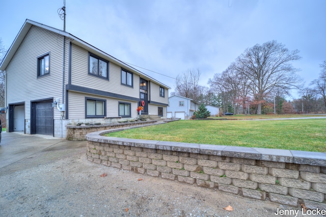 view of front of home featuring a garage and a front lawn