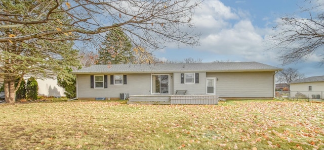 back of house with a yard, a deck, and central air condition unit