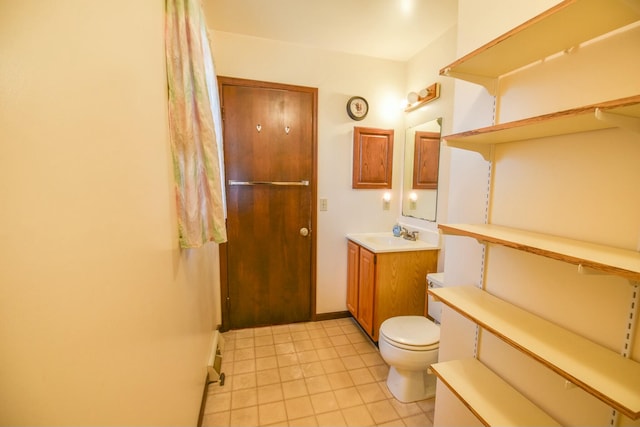 bathroom featuring tile patterned floors, vanity, and toilet