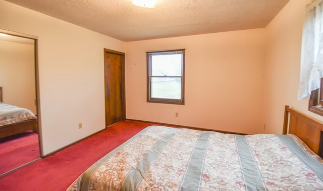 carpeted bedroom featuring a textured ceiling