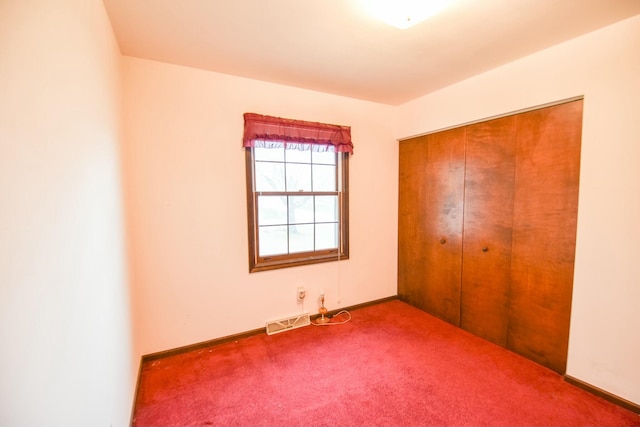 unfurnished bedroom featuring carpet flooring and a closet