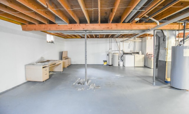 basement with washer and dryer and water heater