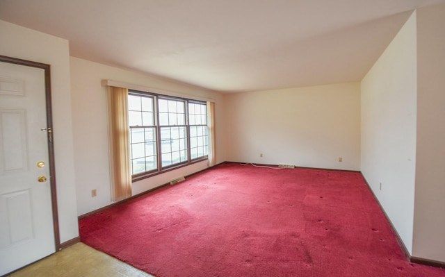 spare room featuring light colored carpet