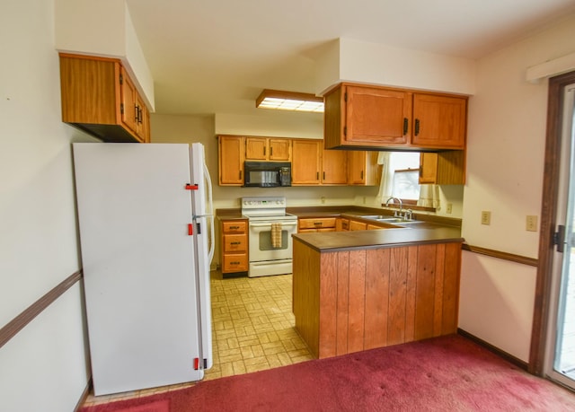 kitchen with kitchen peninsula, light colored carpet, white appliances, and sink