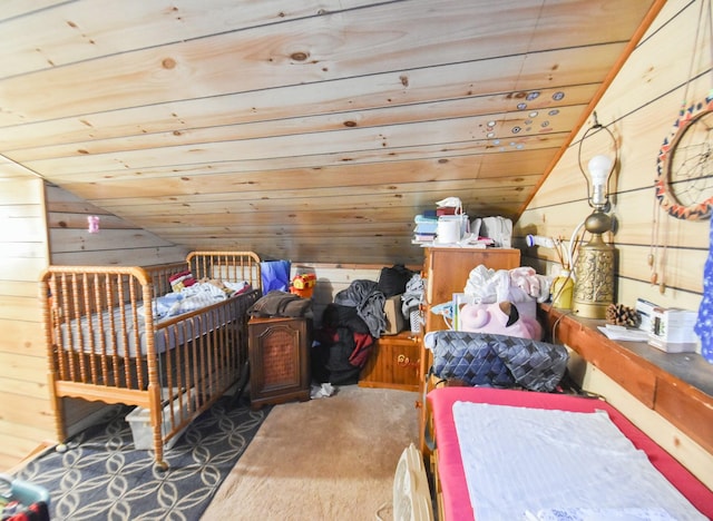 carpeted bedroom featuring wood walls, wooden ceiling, and vaulted ceiling