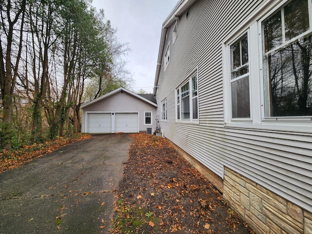 view of home's exterior with a garage and an outdoor structure