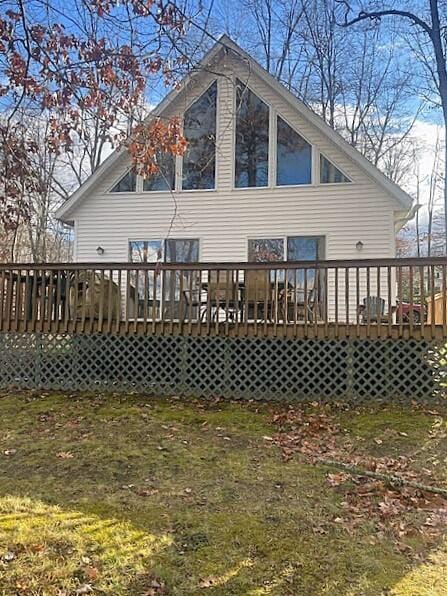 back of house with a yard and a deck