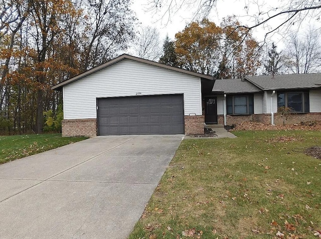 ranch-style house with a garage and a front lawn