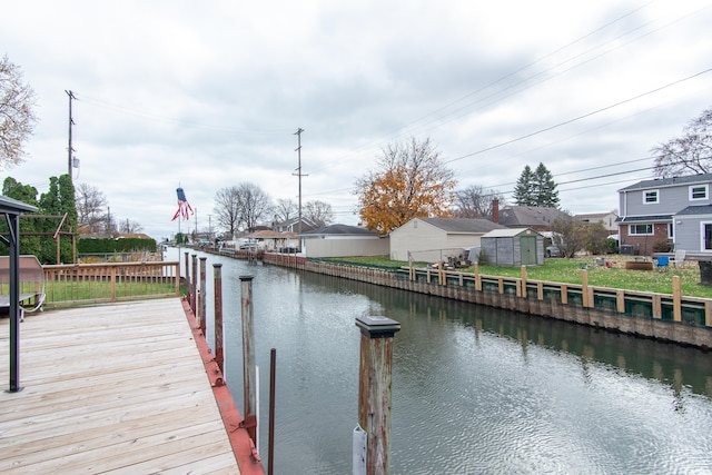 view of dock with a deck with water view