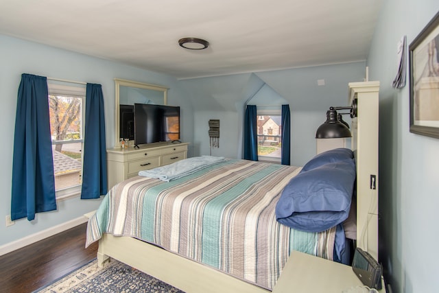 bedroom featuring wood-type flooring and vaulted ceiling