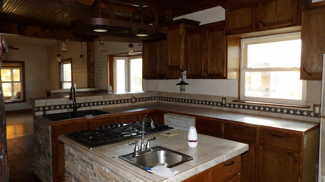 kitchen featuring tile counters, hardwood / wood-style floors, and sink