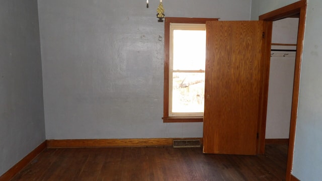 unfurnished bedroom featuring dark wood-type flooring