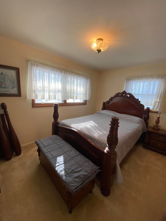 carpeted bedroom featuring multiple windows