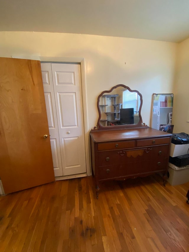 bedroom with hardwood / wood-style floors and a closet