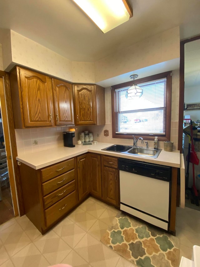 kitchen with dishwasher, sink, and tasteful backsplash