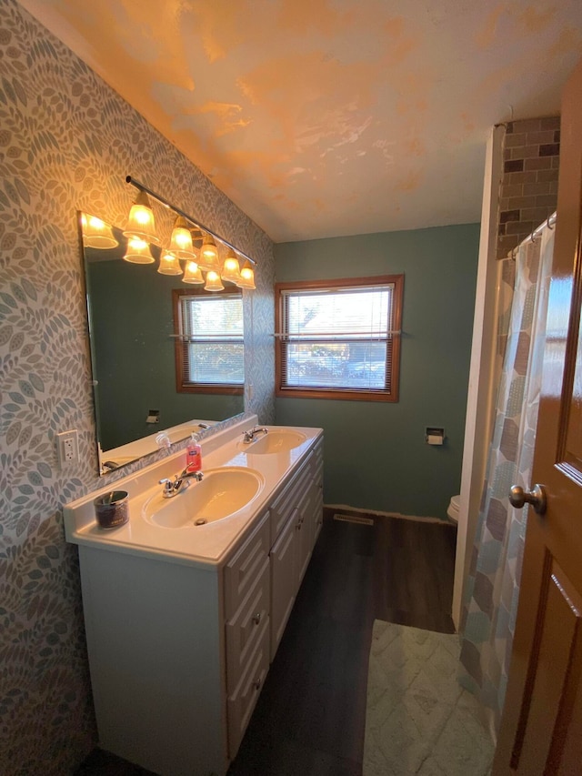 bathroom with a shower with shower curtain, wood-type flooring, vanity, and toilet