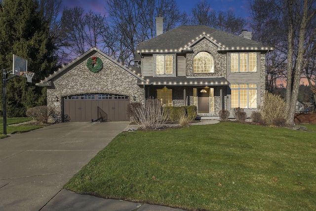 front of property with a yard and a garage