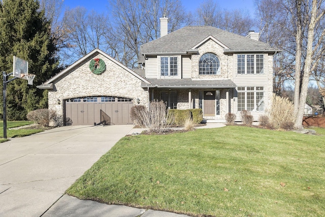 view of property featuring a garage and a front yard