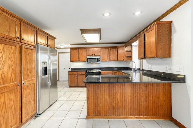 kitchen featuring sink, kitchen peninsula, crown molding, light tile patterned floors, and appliances with stainless steel finishes