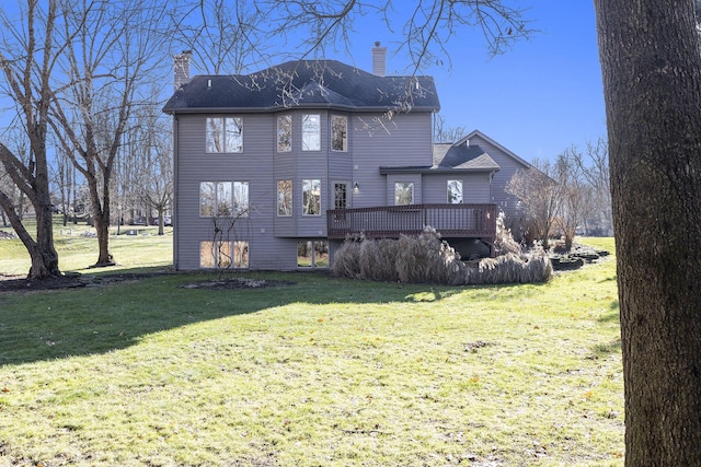 back of property with a lawn and a wooden deck