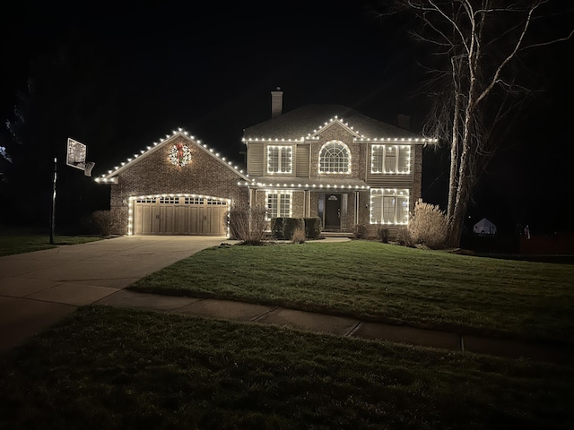 view of front of house featuring a yard and a garage