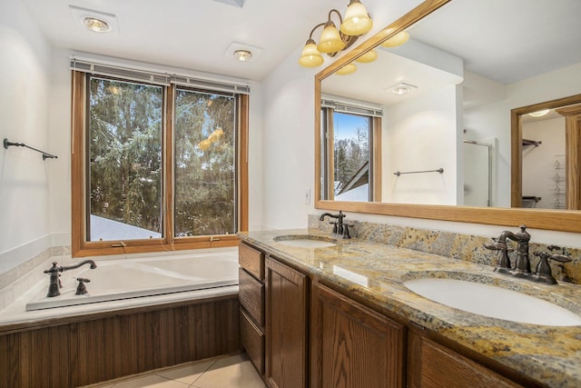 bathroom with tile patterned floors, vanity, and a bath