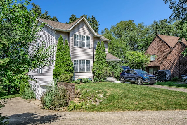 view of home's exterior featuring a lawn and a garage