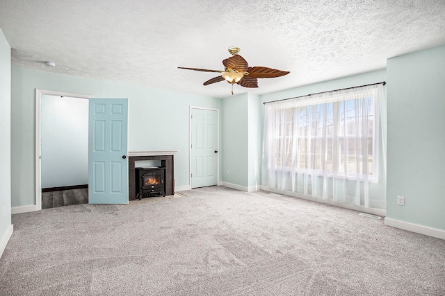 unfurnished living room featuring light carpet, a textured ceiling, and ceiling fan