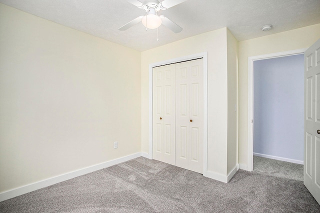 unfurnished bedroom featuring carpet flooring, ceiling fan, a textured ceiling, and a closet