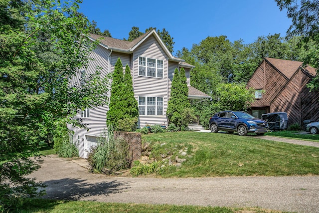 view of property exterior featuring a yard and a garage