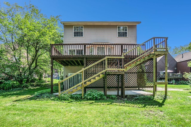 back of property with a lawn, a patio area, and a wooden deck