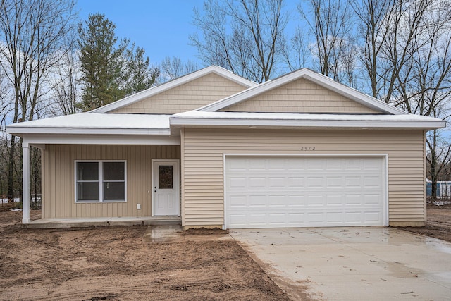 view of front of home with covered porch and a garage